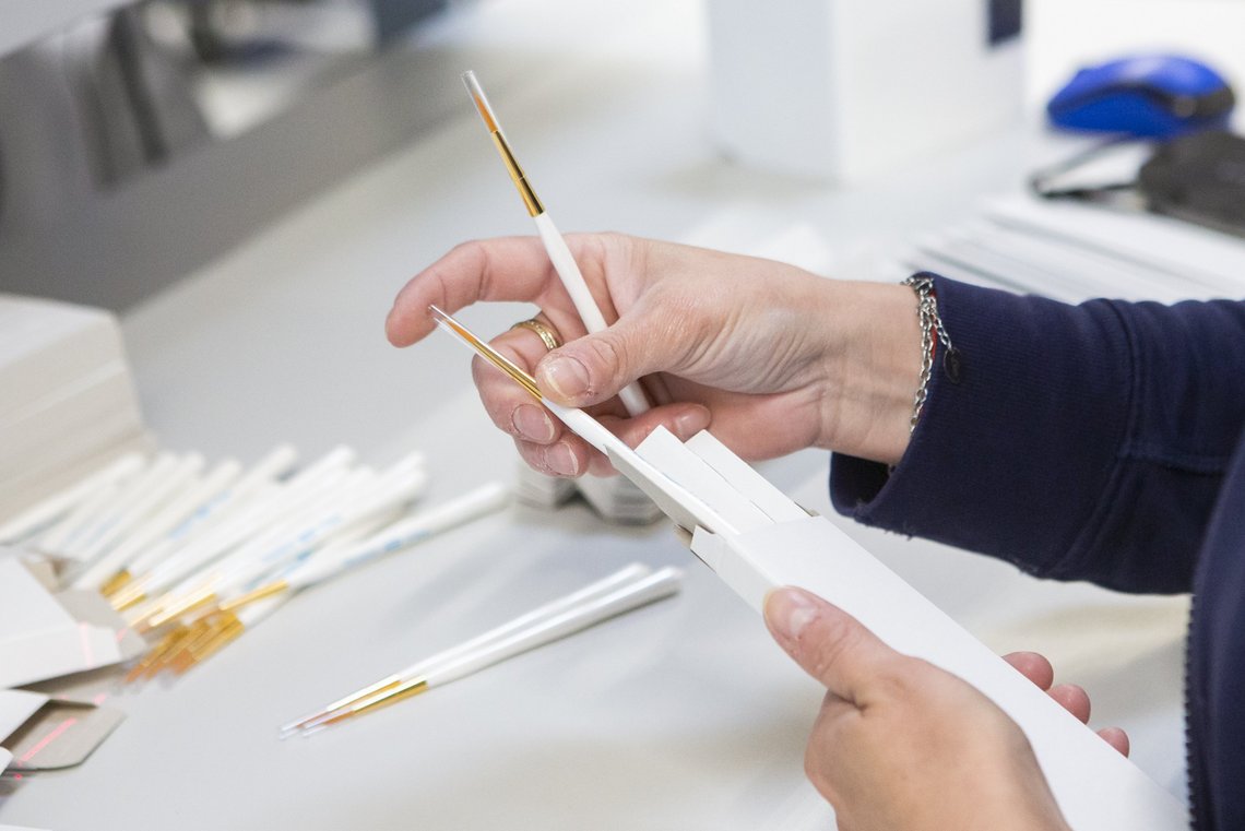 Production worker packing the brushes